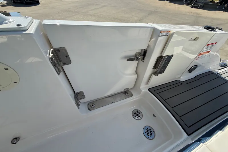 Slide: The Image of 2021 Chaparral 280 OSX boat deck with open hatch and drainage system. - 29