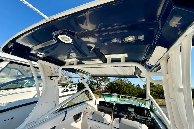 Slide: The Image of 2021 Chaparral 280 OSX boat interior with blue canopy and modern dashboard. - 21