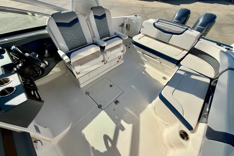 Slide: The Image of 2021 Chaparral 280 OSX boat interior with seating and dual outboard engines. - 20