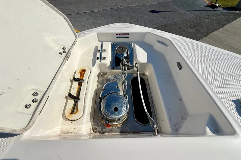 Slide: The Image of Anchor compartment of 2021 Chaparral 280 OSX boat with open hatch. - 15