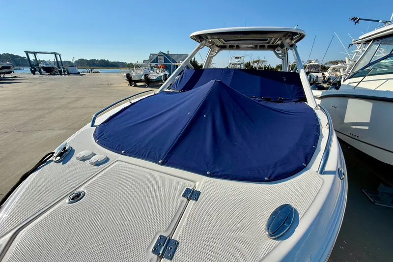 Slide: The Image of 2021 Chaparral 280 OSX boat with blue cover, docked at marina. - 35
