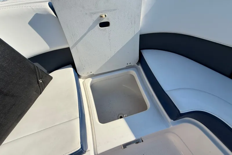 Slide: The Image of 2021 Chaparral 280 OSX boat interior storage compartment with cushioned seating. - 28