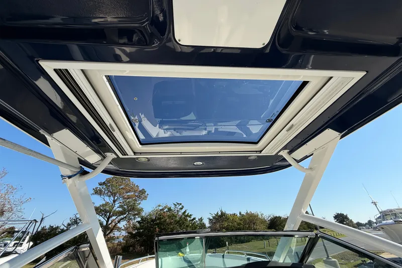 Slide: The Image of 2021 Chaparral 280 OSX boat with a sleek glass sunroof and sturdy frame. - 22