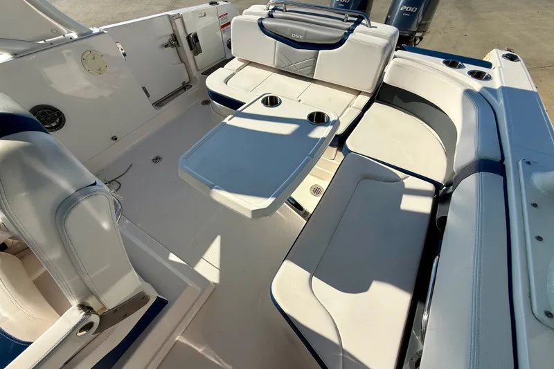 Slide: The Image of 2021 Chaparral 280 OSX boat interior with white seating and table. - 18