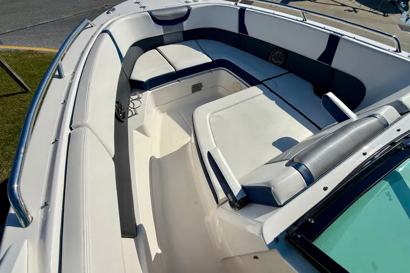Slide: The Image of 2021 Chaparral 280 OSX boat interior with cushioned seating and sleek design. - 13