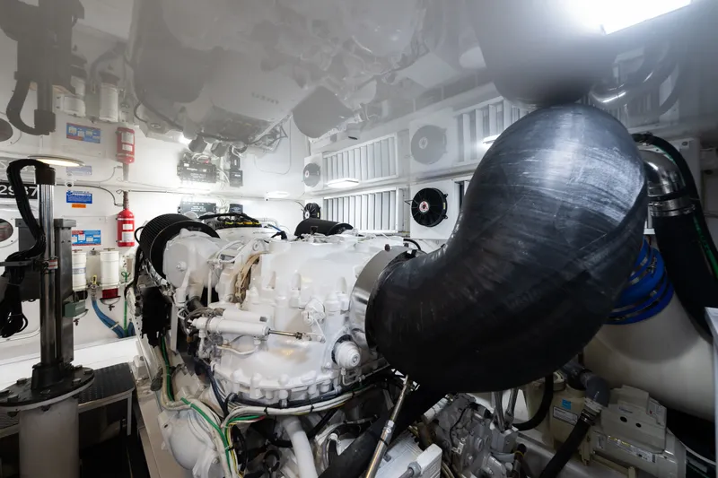 Slide: The Image of Engine room of a 2014 Viking 70C yacht, featuring advanced machinery and equipment. - 74