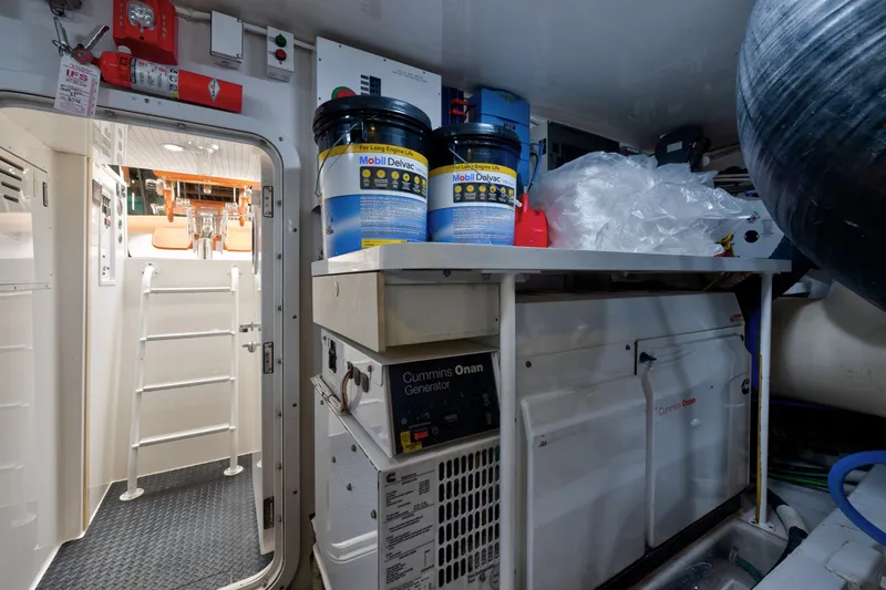 Slide: The Image of Engine room of a 2014 Viking 70C yacht with Cummins Onan generator and Mobil Delvac oil. - 77
