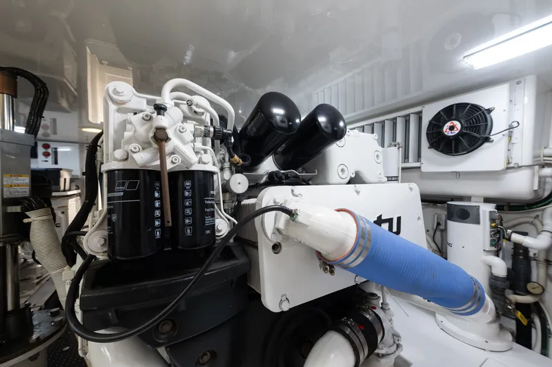 Slide: The Image of Engine room of a 2014 Viking 70C yacht, showcasing mechanical components and systems. - 79