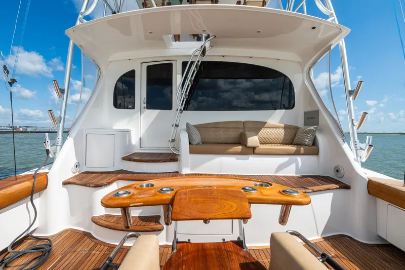 Slide: The Image of Luxurious 2014 Viking 70C yacht deck with seating, wooden accents, and ocean view. - 16