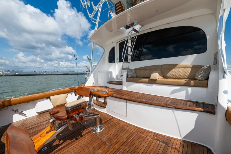 Slide: The Image of Luxurious 2014 Viking 70C yacht deck with seating, fishing chair, and ocean view. - 19