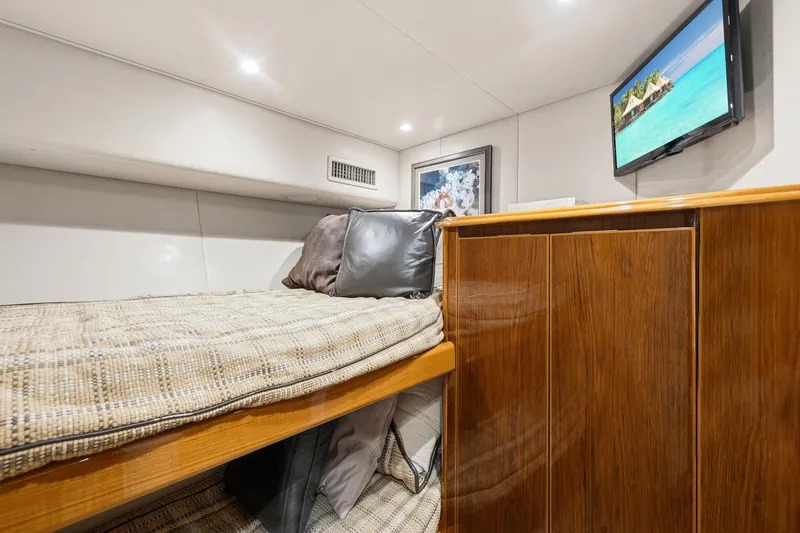 Slide: The Image of Luxurious cabin interior of 2014 Viking 70C yacht with cozy bed and wall-mounted TV. - 48