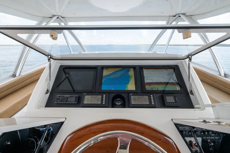 Slide: The Image of Cockpit of 2014 Viking 70C yacht with advanced navigation displays and controls. - 70