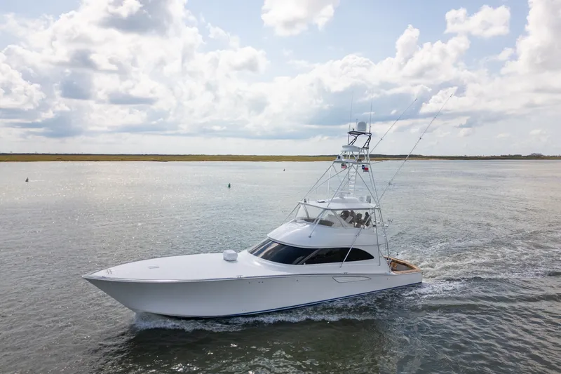 Slide: The Image of 2014 Viking 70C yacht cruising on open water under a cloudy sky. - 6