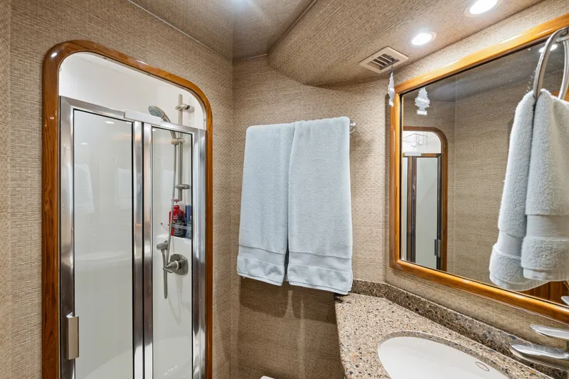 Slide: The Image of Luxurious bathroom in 2014 Viking 70C yacht with shower and granite countertop. - 49