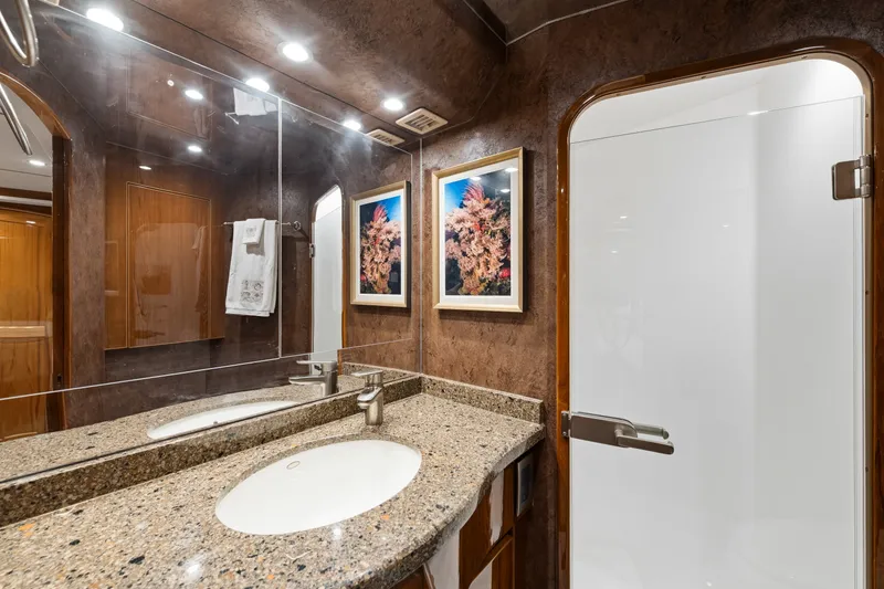 Slide: The Image of Luxurious bathroom interior of 2014 Viking 70C yacht with granite countertop and framed artwork. - 57