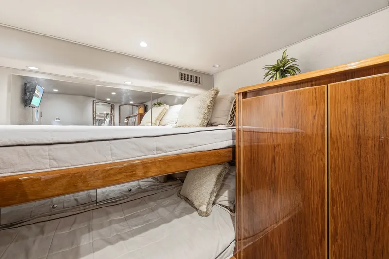 Slide: The Image of Luxurious interior of 2014 Viking 70C yacht with elegant wood finish and cozy bedding. - 52