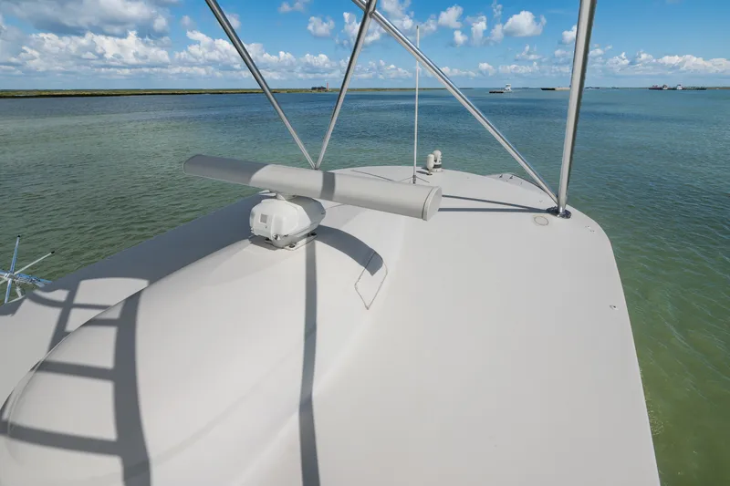 Slide: The Image of 2014 Viking 70C yacht radar equipment on deck, overlooking calm waters and blue sky. - 43