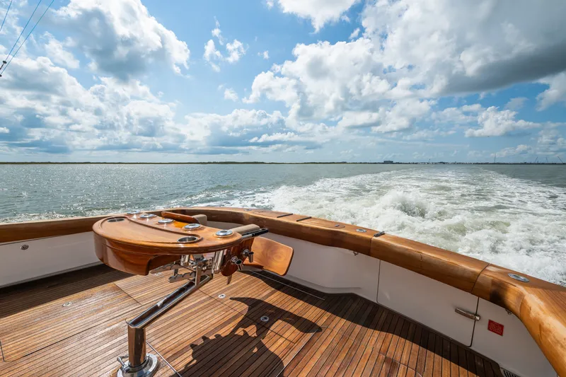 Slide: The Image of Luxury Viking 70C yacht deck with ocean view, 2014 model, under a partly cloudy sky. - 22