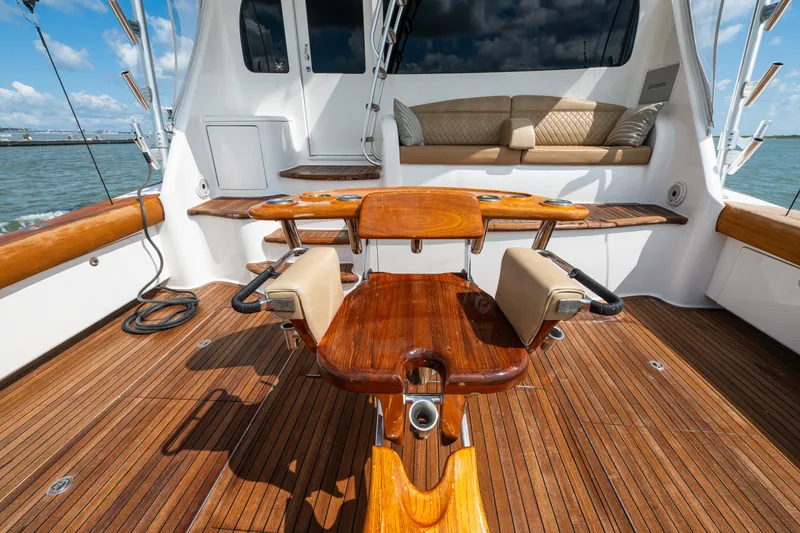 Slide: The Image of Luxurious 2014 Viking 70C yacht deck with polished wood and comfortable seating. - 17