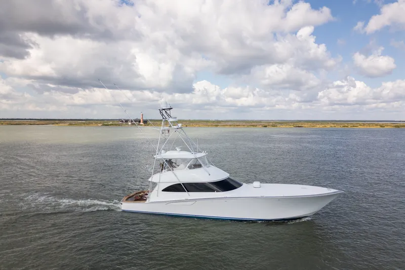 Slide: The Image of 2014 Viking 70C yacht cruising on open water under cloudy skies. - 3