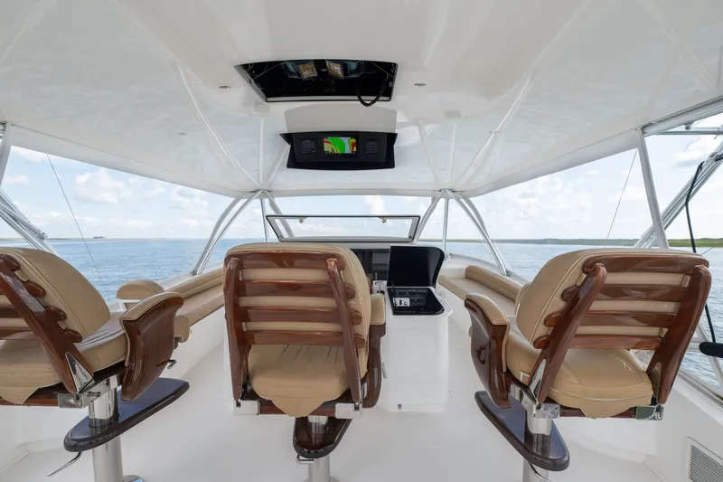 Slide: The Image of Interior view of 2014 Viking 70C yacht helm with luxurious seating and navigation equipment. - 29