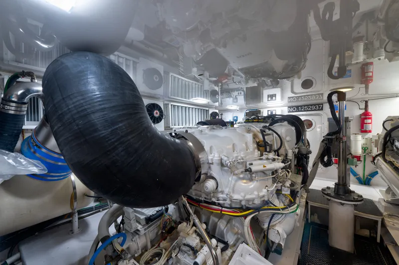 Slide: The Image of Engine room of a 2014 Viking 70C yacht, showcasing complex machinery and components. - 73