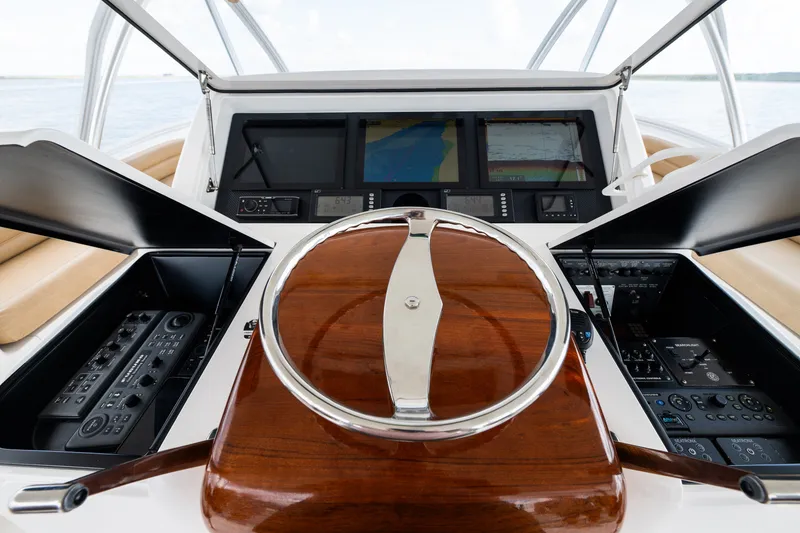 Slide: The Image of Steering console of a 2014 Viking 70C yacht with navigation controls and displays. - 26