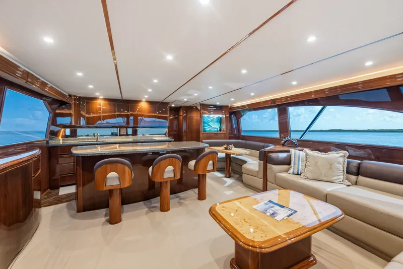 Slide: The Image of Luxurious interior of 2014 Viking 70C yacht with elegant seating and panoramic windows. - 59
