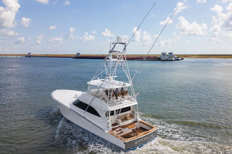 Slide: The Image of 2014 Viking 70C yacht cruising on open water under a partly cloudy sky. - 7