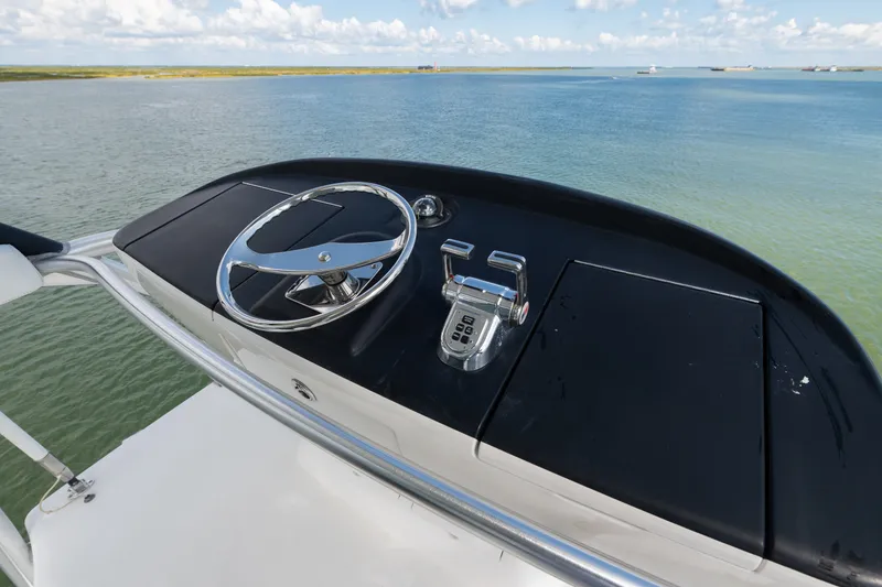 Slide: The Image of Steering console of 2014 Viking 70C yacht overlooking calm waters. - 41