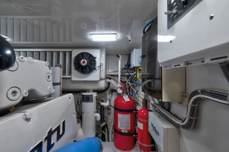 Slide: The Image of Engine room of 2014 Viking 70C yacht with machinery and fire extinguishers. - 82