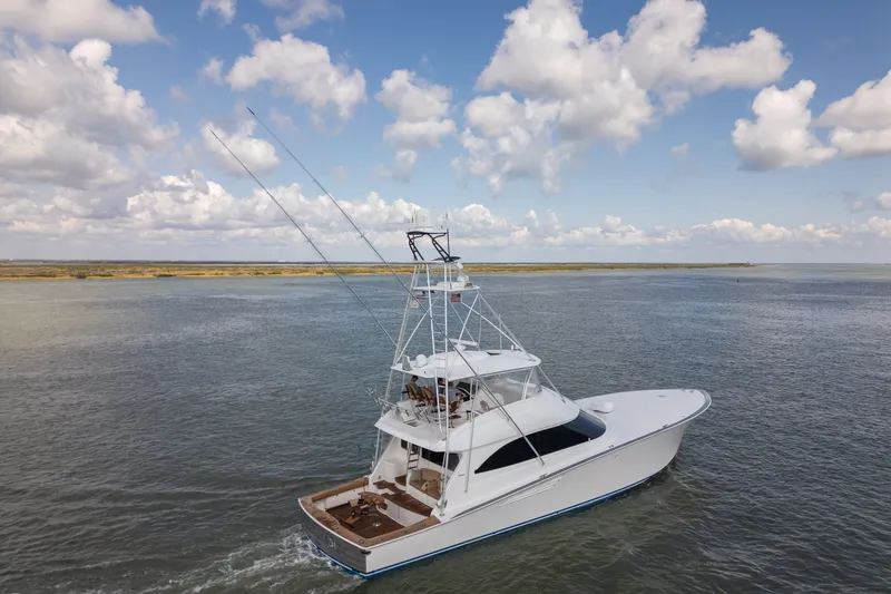 The Image of Luxury 2014 Viking 70C yacht cruising on open water under a cloudy sky. - 2