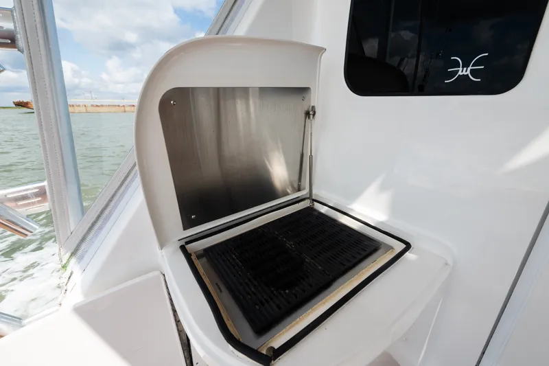Slide: The Image of Outdoor grill on 2014 Viking 70C yacht, near water, under cloudy sky. - 24