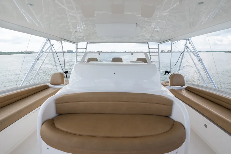 Slide: The Image of Luxurious 2014 Viking 70C yacht interior with tan seating and ocean view. - 33