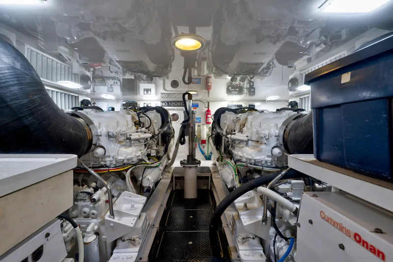 Slide: The Image of Engine room of a 2014 Viking 70C yacht, featuring dual engines and Cummins Onan generator. - 71