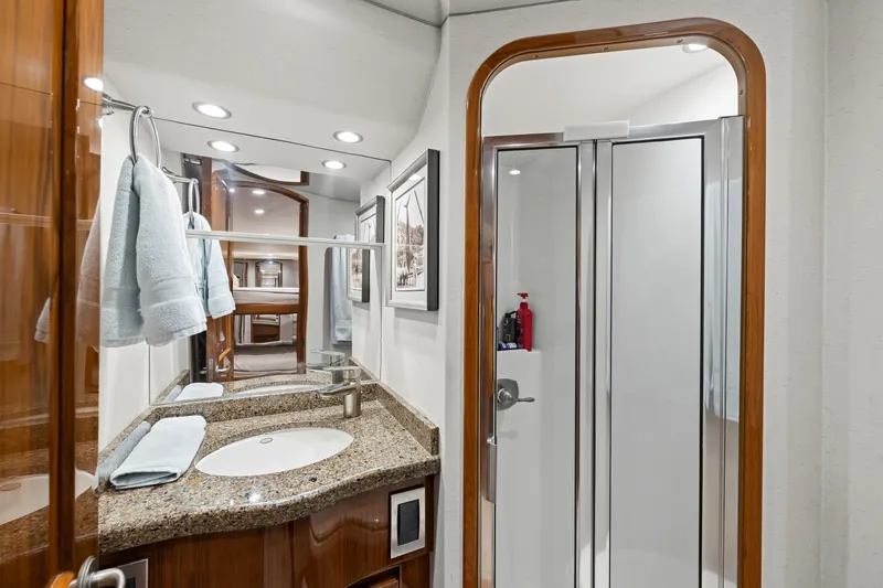 Slide: The Image of Luxurious bathroom in 2014 Viking 70C yacht with granite countertop and modern shower. - 53
