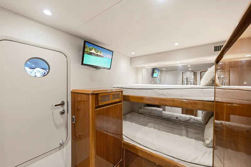 Slide: The Image of Interior of 2014 Viking 70C yacht with bunk beds and wall-mounted TV. - 51