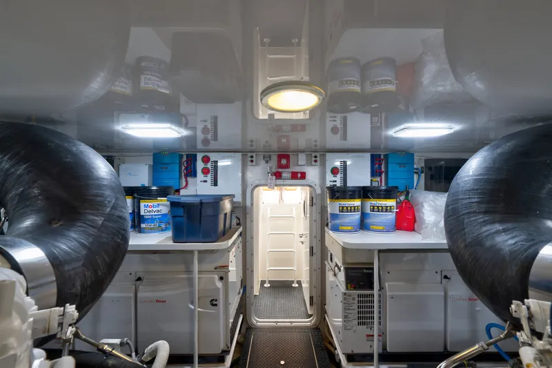 Slide: The Image of Engine room of a 2014 Viking 70C yacht, featuring equipment and supplies. - 76