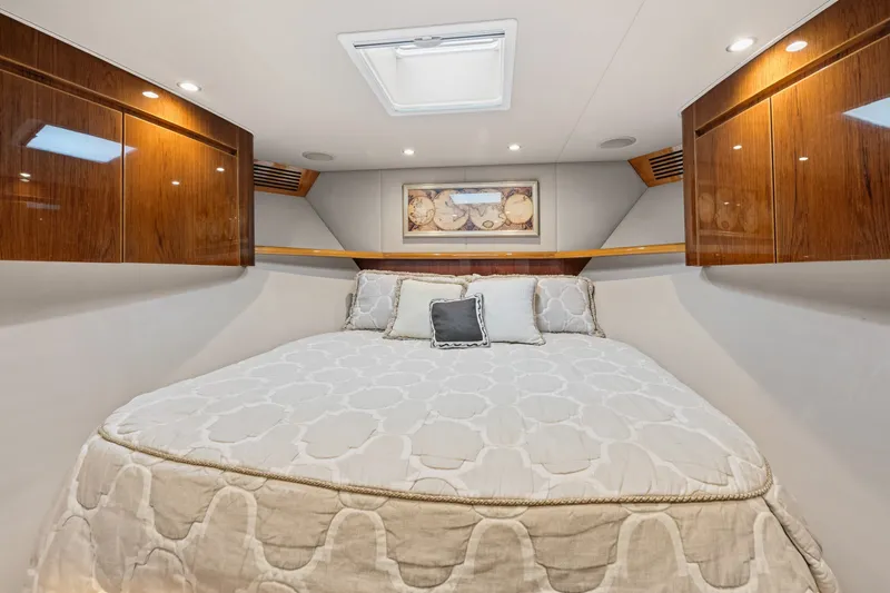 Slide: The Image of Luxurious cabin interior of 2014 Viking 70C yacht with elegant bedding and wood cabinetry. - 44