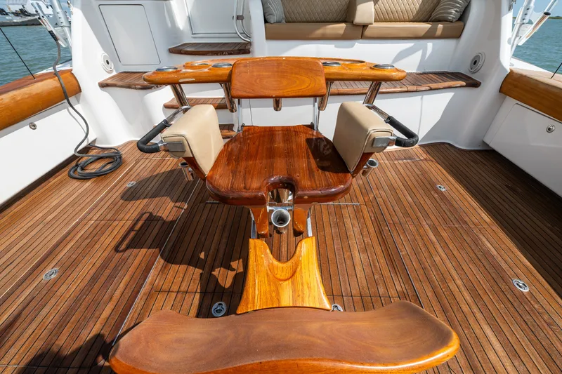 Slide: The Image of Luxurious 2014 Viking 70C yacht deck with polished wood and comfortable seating. - 18