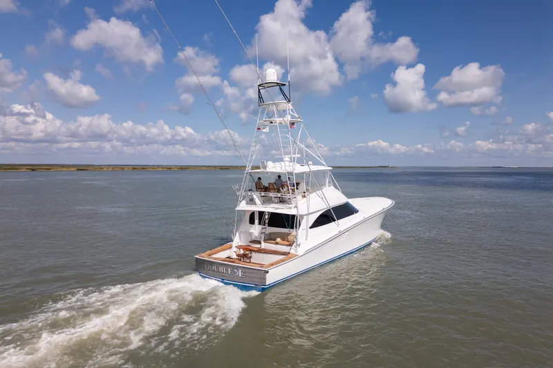 Slide: The Image of 2014 Viking 70C yacht cruising on open water under a partly cloudy sky. - 1