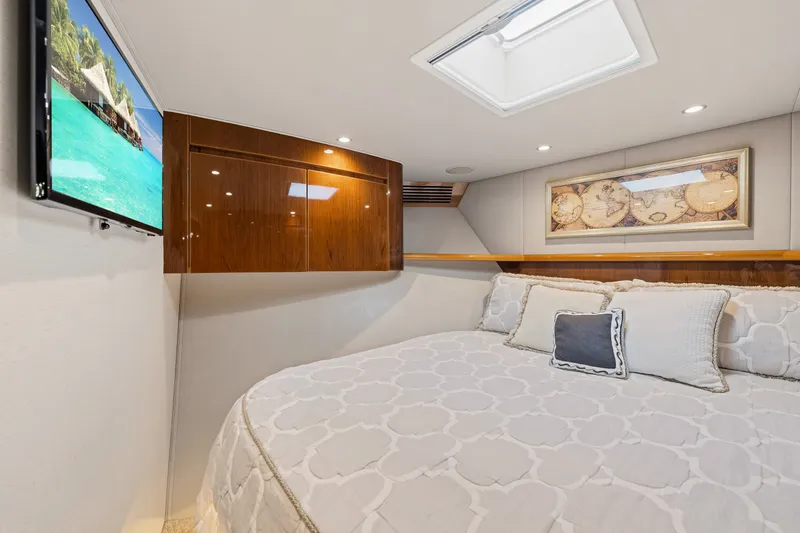 Slide: The Image of Luxurious cabin interior of 2014 Viking 70C yacht with cozy bed and wall-mounted TV. - 45