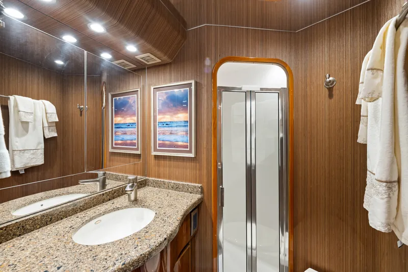 Slide: The Image of Luxurious bathroom in 2014 Viking 70C yacht with granite countertop and elegant wood paneling. - 47