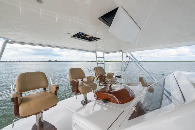 Slide: The Image of Flybridge of 2014 Viking 70C yacht with helm chairs and ocean view. - 38