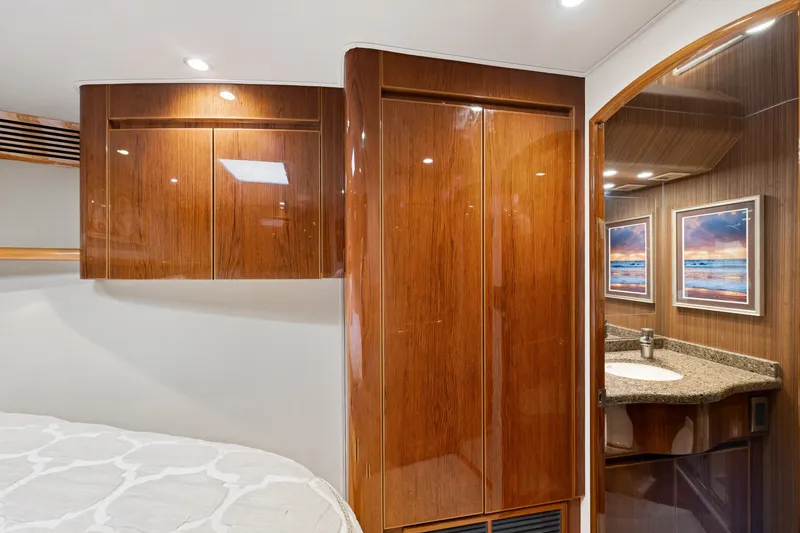 Slide: The Image of Luxurious 2014 Viking 70C yacht interior with polished wood cabinets and elegant bathroom. - 46