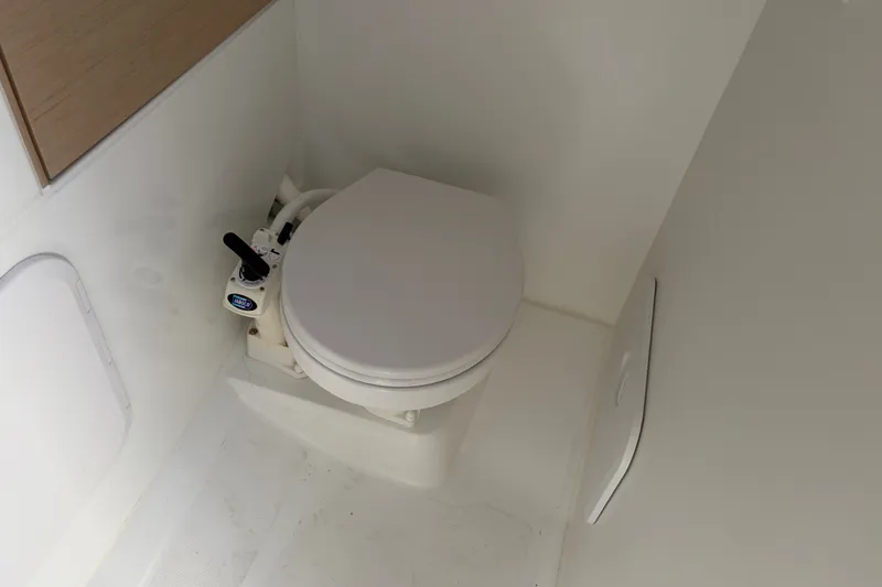 Slide: The Image of Beneteau Oceanis 30.1 2021 yacht bathroom with compact marine toilet. - 12