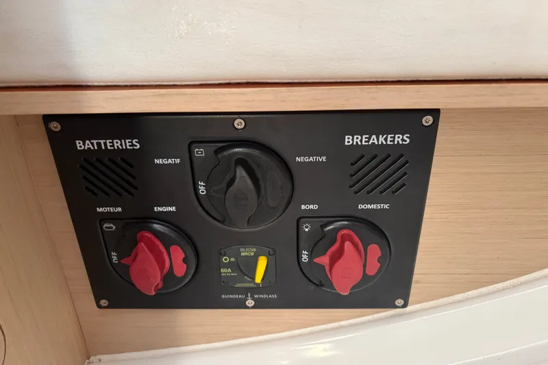 Slide: The Image of Control panel of a 2021 Beneteau Oceanis 30.1 sailboat, featuring battery and breaker switches. - 23