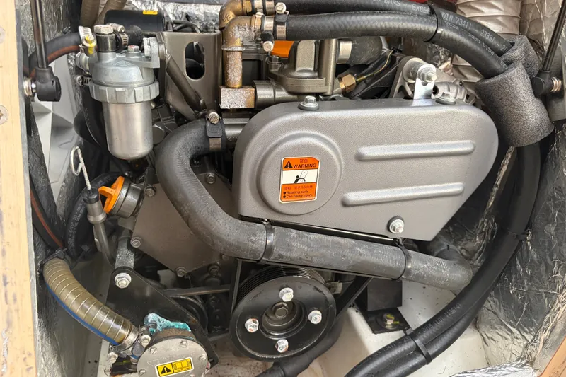 Slide: The Image of Engine compartment of a 2021 Beneteau Oceanis 30.1 sailboat, showcasing mechanical components. - 17