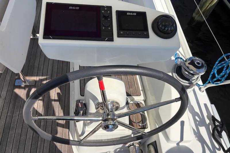 Slide: The Image of Steering wheel and navigation instruments on a 2021 Beneteau Oceanis 30.1 sailboat. - 27