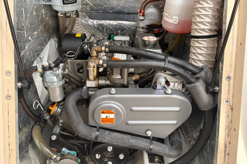 Slide: The Image of Engine compartment of a 2021 Beneteau Oceanis 30.1 sailboat, showcasing mechanical components. - 16